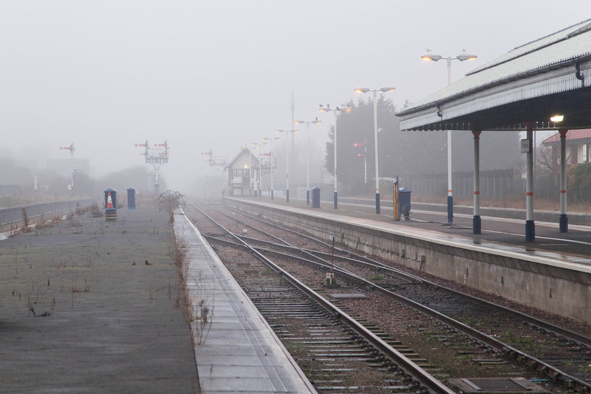 Skegness Station 
 The combination of the dying winter light and the haar drifting in from the North Sea made our arrival at Skegness a pretty dismal one! Here, looking up the platforms all that is left of this once quite substantial station can be seen along with the signal box and associated semaphores. 
 Keywords: Skegness Station