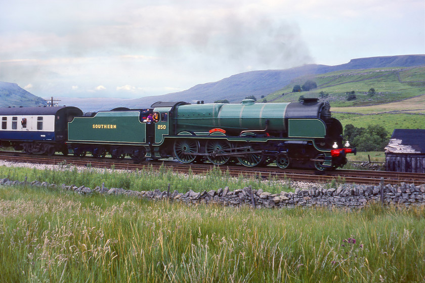 850, outward leg of The Cumbrian Mountain Express, Carlisle-Skipton, Ais Gill Summit SD775967 
 A broadside of 850 'Lord Nelson' at Ais Gill summit going well after climbing 'the long drag' up from Appleby. Passengers onboard had enjoyed steam haulage from Carlisle that would finish at Skipton for 4498 'Sir Nigel Gresley' to take the return train to Carnforth. 850 was one of just sixteen members of the class built at Eastleigh in 1926. Initially, their performance was poor but Maunsell persevered with his design and after a number of major adaptions they finally ended up producing the power expected of them. Under British Railways the locomotive became a Class 7P and carried the number 30850, being withdrawn in 1962 and is the only example preserved.

There is an audio recording of this event on my youtube channel, see...https://youtu.be/0CmKCG9W2J0 
 Keywords: 30850 Lord nelson Maunsell 850 Cumbrian Mountain Express Carlisle-Skipton Ais Gill Summit SD775967 S & C Settle and Carlisle The long drag