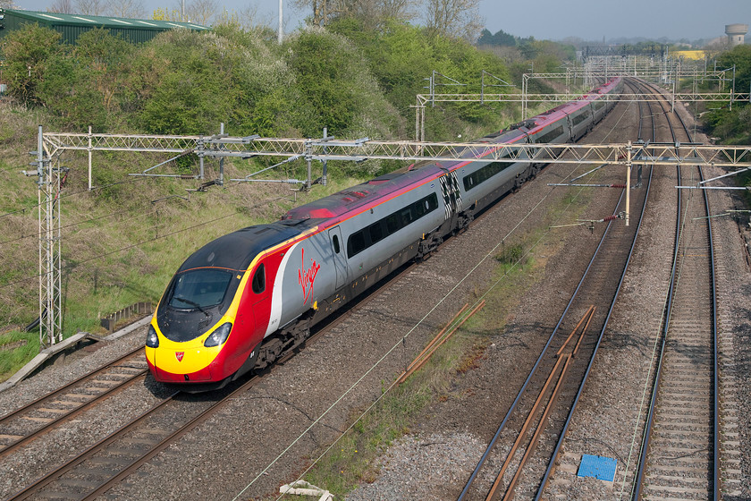 390121, VT 08.15 Manchester Piccadilly-London Euston (1A14), Victoria bridge 
 In glorious spring sunshine, 390121 heads south past Victoria bridge near Roade on the WCML with the 08.15 Manchester to Euston 1A14 service. 
 Keywords: 390121 08.15 Manchester Piccadilly-London Euston 1A14 Victoria bridge