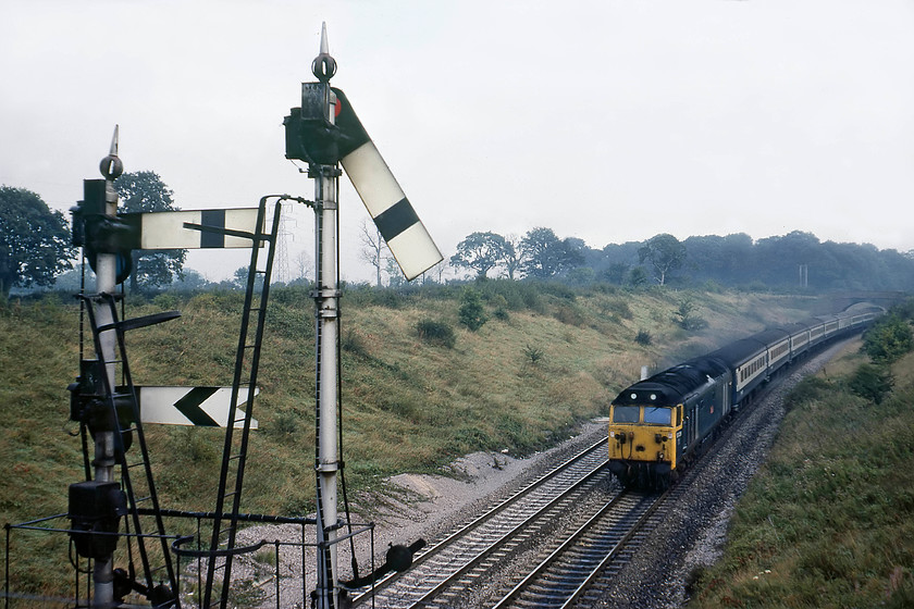 50039, 08.30 London Paddington-Paignton (1B34), Clink Road Junction 
 50039 'Implacable' approaches Clink Road Junction from the east powering the 08.30 Paddington to Paignton service. The train is about to pass Clink's down main and down Frome bracket signals. The cut-off (main) line post is taller as the more important route. The whole structure is late GWR/British Railways tubular steel construction painted in WR silver. The distant is motor operated. 
 Keywords: 50039 08.30 London Paddington-Paignton 1B34 Clink Road Junction