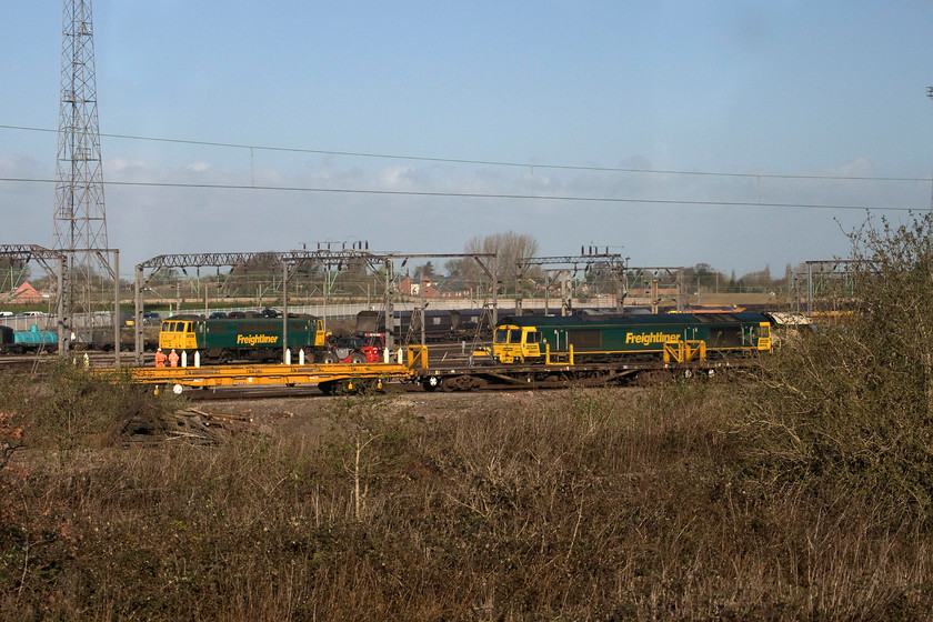 86639 & 66953, stabled, Crewe Basford Hall 
 As we approached Crewe, our train was checked to a crawling pace, presumably whilst we were being allocated a platform. It gave the opportunity to get a reasonable picture of veteran AC 86639 and 66953 both stabled in Basford Hall yard. There is always a tantalising selection of locomotives in the yard just south of Crewe, but all too often it is impossible to get the numbers and to take pictures so this one makes a pleasant exception. 
 Keywords: 86639 66953 stabled Crewe Basford Hall