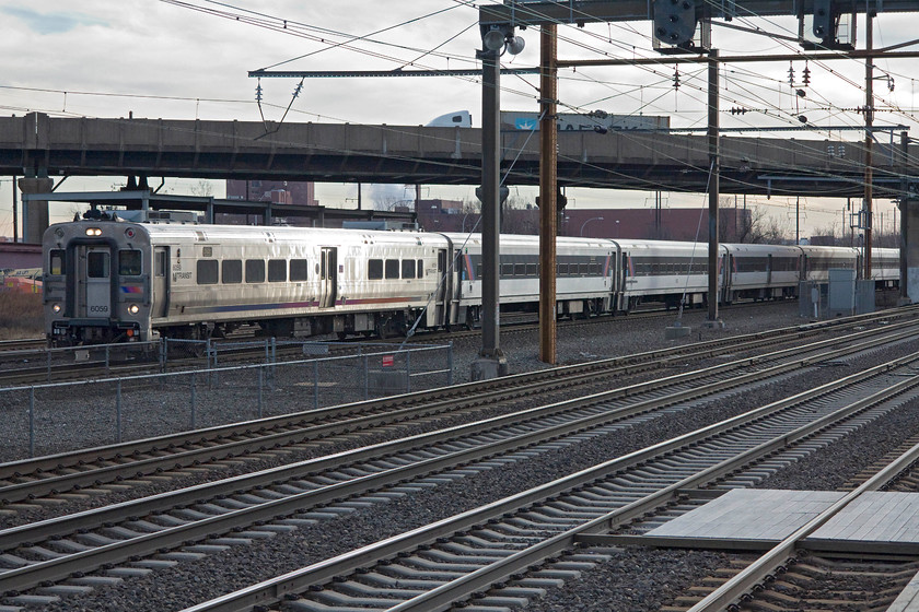 6059, 13.44 Trenton-New York Penn (3850), Newark International Airport station 
 Constructed entirely from stainless steel a Comet V uint 6059 arrives at Newark International Airport station with the 13.44 Trenton to New York Penn 3850 service. This is effectively a DVT attached to a set of stock with a locomotive doing the work in a push-pull manner at the other end. These units were manufactured by Alstom during 2002 and have been in operation in and around the New York metropolitan area since giving, generally, a good service apart from some issues with their door locking and release mechanism. 
 Keywords: 6059 13.44 Trenton-New York Penn 3850 Newark International Airport station