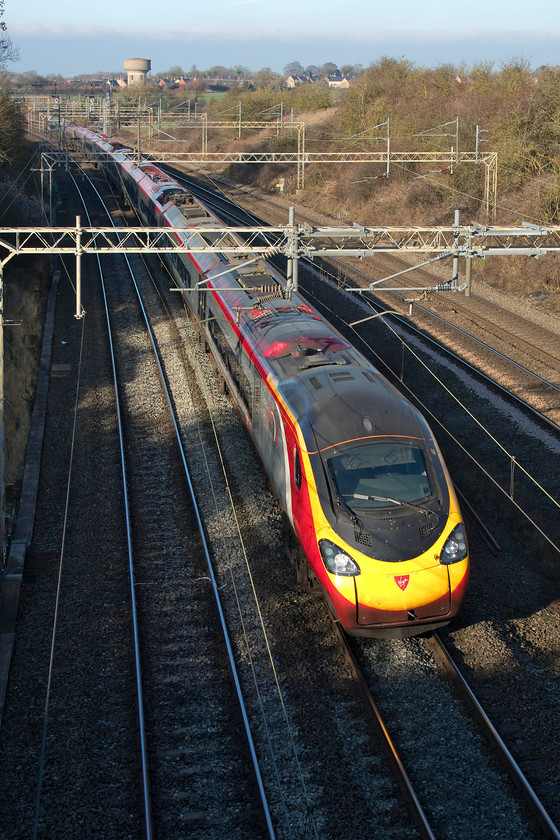 390151, VT 11.07 Wolverhampton-London Euston (1B13, 4E), Victoria bridge 
 In stunning winter light 390151 'Virgin Ambassador' passes Victoria bridge just south of Roade working the 1B13 11.07 Wolverhampton to Euston. In all honesty, I really do prefer this lighting to the much stronger and more direct light of summer that produces much heavier shadows. The problem is as the the sun is so low, catching trains in the sunlight is the tricky thing to achieve! 
 Keywords: 390151 11.07 Wolverhampton-London Euston 1B13 Victoria bridge