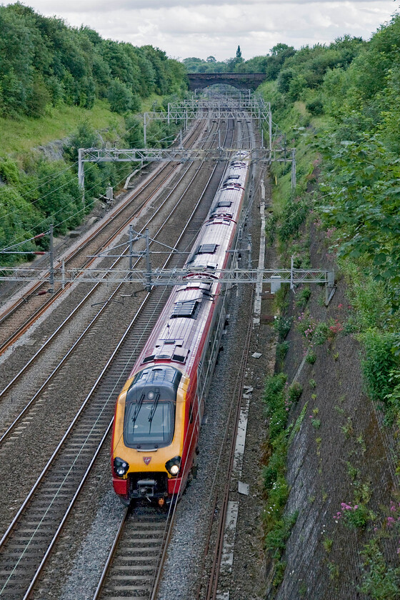 Class 221, VT 17.43 London Euston-Preston (9P95), Roade cutting 
 A Virgin Voyager passes through Roade cutting working the 17.43 Euston to Preston 9P45 train. Without wishing to bore my readers I am going to repeat my request for information as to why thirsty and dirty diesels are restored to operate under the wires for the entire length of their journey. 
 Keywords: Class 221 VT 17.43 London Euston-Preston 9P95 Roade cutting Virgin Trains Voyager