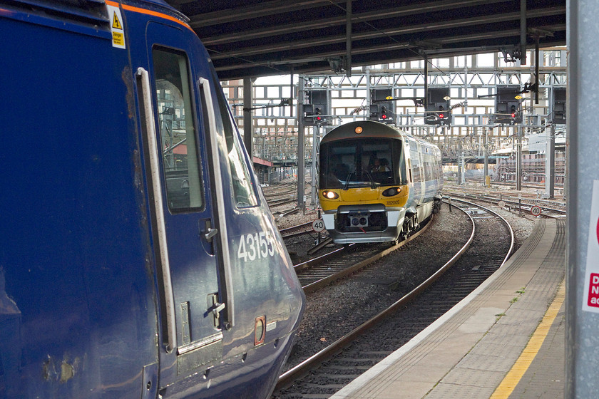 43155, GW 14.02 London Paddington-Bristol Temple Meads (1C17) & 332005, HX 13.57 Heathrow T5-London Paddington (1Y57), London Paddington station 
 At the far country end of London Paddington station, 43155 'The Red Arrows - 50 Seasons of Excellence' is now nearly twenty minutes late leaving with the 14.02 to Bristol Temple Meads. It did actually get going in the next five minutes or so. Meanwhile, 332005 arrives with the 13.57 from Heathrow Terminal five. Despite the time of day and year, I am pleasantly surprised with the lighting in this image, even more so as it is taken under Bishop's Bridge. 
 Keywords: 43155 14.02 London Paddington-Bristol Temple Meads 1C17 332005 13.57 Heathrow T5-London Paddington 1Y57 London Paddington station