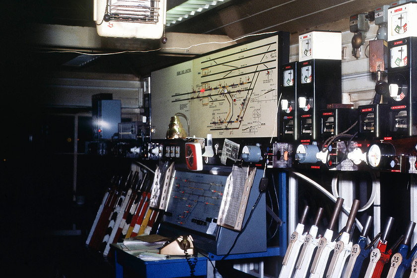 Interior, Engine Shed Junction signal box 
 In the midst of time I have forgotten how we managed to gain access to Engine Shed Junction signal box and even where it was located. All I do know is that it was located adjacent to the MML at the southern end of the Kentish Town triangle. The signalman must have afforded us access to the box and allowed me to use my flash to take this image of the levers and track diagram. Notice the number of white levers (OOU) and the mini panel above the telephone. 
 Keywords: Interior Engine Shed Junction signal box