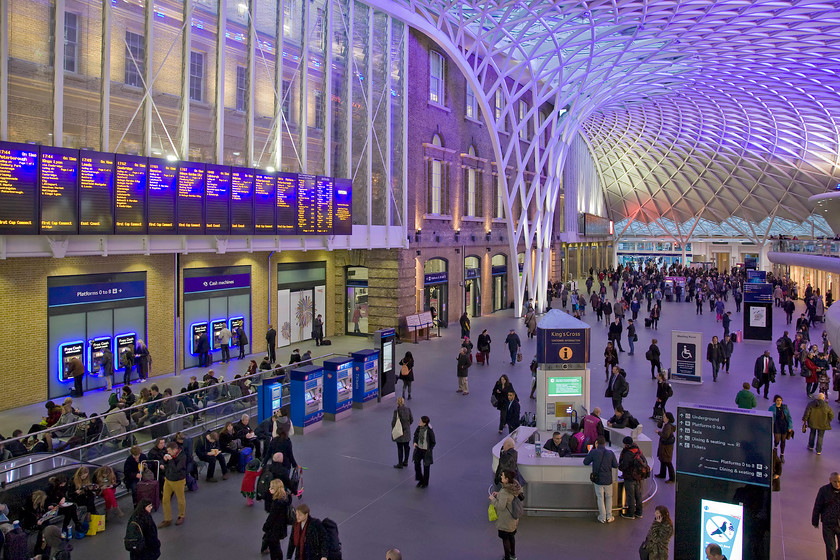 Concourse, London King's Cross station, 
 Designed by the internationally renowned architect John McAslan the impressive departure concourse at King's Cross opened two years ago in 2012. Its claimed that the roof is the longest single-span station structure in Europe with the semi-circular structure having a radius of fifty-four metres and it certainly looks impressive during the hours of darkness with its purple lighting. The original Great Northern station designed by Sir William Cubitt can still be seen having been functionally incorporated into the new structure. 
 Keywords: John McAslan