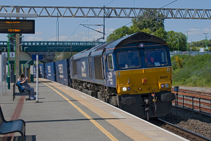 66427, 13.37 DIRFT-Tilbury (4L48, 15L), Tring station 
 The daily 4L48 13.37 Daventry (DIRFT) to Tilbury heads southwards through Tring station led by frequent DRS performer 66427. This service dubbed the Tesco Express is a regular-as-clockwork train that leaves DIRFT just after lunch and seems to always get to Tilbury pretty quickly with quite tight timings. The balancing working returns as 4M07 leaving Tilbury's vast facility the next morning. Along with various other services, this makes the Tesco distribution centre at DIRFT a huge and twenty-four-hour operation. 
 Keywords: 66427 13.37 DIRFT-Tilbury 4L48 Tring station DRS Tesco Express