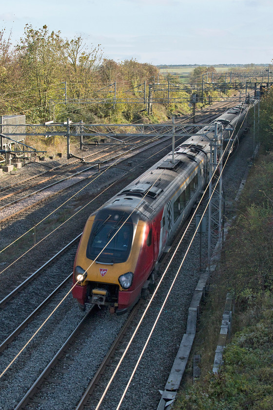 Class 221s, VT 12.43 London Euston-Edinburgh Waverley (9S70, RT), Victoria Bridge 
 What a waste of resources! A pair of Virgin 221s race north past Victoria Bridge in south Northamptonshire forming the 12.42 Euston to Edinburgh. The economics of running a double manned ten car DMU all the way under the wires is farcical, with each carriage having a thirsty 750Hp Cummins diesel engine underneath. Surely, planners could organise a Pendolino from the fleet to run this service or I am I missing something, advice willingly taken! 
 Keywords: Class 221s 12.43 London Euston-Edinburgh Waverley 9S70 Victoria Bridge