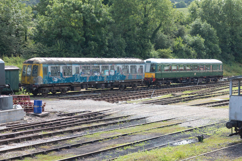 M51567 & W55006, stabled, Wirksworth yard 
 Before and after! To the left in Wirksworth's yard work appears to be underway to restore class 108 DMC M51567. It has led a sad life since withdrawal in the mis 1990s with it passing from location to location with work to restore it never quite getting started. To the right is the finished article. Class 122 bubble car W55006 is now in regular use on the Ecclesbourne Railway after its restoration was completed three years ago in 2013. 
 Keywords: M51567 W55006 Wirksworth yard