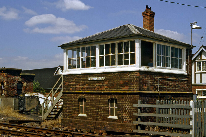 Bromfield signal box (LNW & GW Joint, 1873) 
 The LNW & GW joint signal box at Bromfield is a smaller version of the previous box at Woofferton and what a smashing design they are! This 1873 structure is perfectly symmetrical and has a beautifully simple design. It is located just to the west of the village it is named after with Ludlow racecourse immediately behind it just out of view in this photograph. I took a photograph from a near identical position when I revisited the location in 2016 with the similarities clear to see..... https://www.ontheupfast.com/p/21936chg/25752986804/bromfield-signal-box 
 Keywords: Bromfield signal box LNW & GW Joint 1873