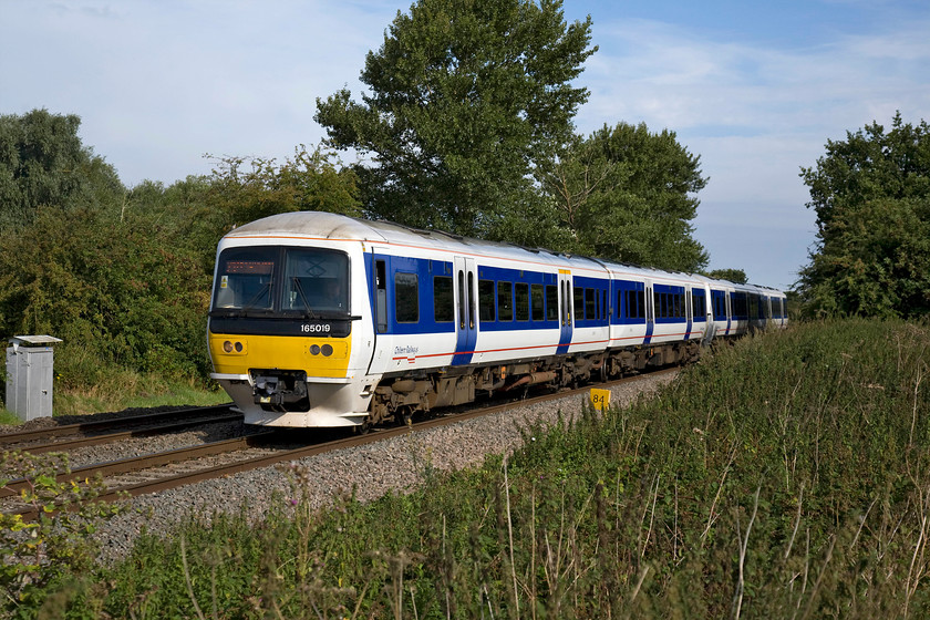 165019, CH 09.25 Banbury-London Marylebone (2H31), King`s Sutton SP486377 
 Chiltern Railway's 165019 is running slightly slower than normal as it approaches King's Sutton with the 09.25 Banbury to Marylebone service. The reason for the restricted speed is that it is fairly close behind the previous charter, 'The Bournemouth Flyer' that itself was trailing a Freightliner working. However, things would soon pick up for the Chiltern service as it will stop at King's Sutton station and then diverge from the route of the preceding trains at Aynho Junction. 
 Keywords: 165019 09.25 Banbury-London Marylebone 2H31 King`s Sutton SP486377 Chiltern Railways Turbo