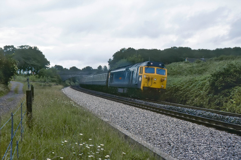 50013, 06.35 Bristol Temple Meads-Plymouth (1B16), Burlescombe ST071168 
 50013 'Agincourt' sweeps around a curve on the descent from Whiteball passing Burlescombe. It is leading the 1B16 06.35 Bristol Temple Meads to Plymouth service that was always a pretty good bet to be hauled by a Class 50. Proudly wearing its new headlight indicated that 'Agincourt' had undergone refurbishment (even though some members of the class emerged with plated holes due to supply issues of the component). 'Agincourt' was the sixth member of the class to emerge from Doncaster just over a month previously to this photograph being taken. 
 Keywords: 50013 06.35 Bristol Temple Meads-Plymouth 1B16 Burlescombe ST071168 Agincourt