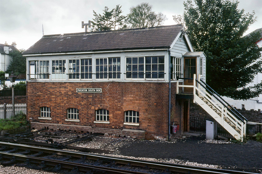 Paignton South Signal Box (GW, date not known) 
 A second view of Paignton South signal box taken from a position standing on the top of a wall. It's an example of a Great Western Type 3 box with the slightly steeper pitched roof and a lovely external timber porch. The six pane sliding windows are typical of GW boxes as are the arched locking room windows. The box survived another six years before giving way to the new MAS signalling controlled by Exeter panel. 
 Keywords: Paignton South Signal Box (GW, date not known)