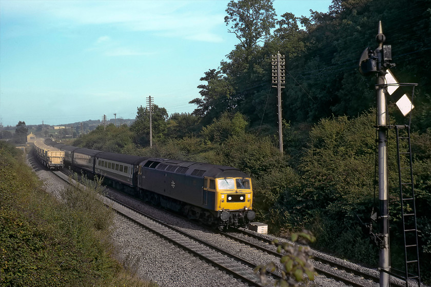 47478, 12.30 London Paddington-Paignton (1B76) & 47119, up Foster Yoeman stone train, Blatchbridge Junction 
 Taken from the B3092 road bridge south out of Frome, 47478 is seen leading the 12.30 Paddington to Paignton. I was probably disappointed to see a class 47 on this working, hoping for a class 50. It has just passed an up Foster Yoeman stone train, complete with its customary trail of dust, that was headed by 47119. The down-home signal for Blatchbridge Junction is seen on the wrong side of the line for sighting purposes due to the sharp left-hand curve. At this time, both 47s were Western Region based, the former at Old Oak Common and the latter at Cardiff Canton, neither of with are with us today, 
 Keywords: 47478 12.30 London Paddington-Paignton 1B76 47119 up Foster Yoeman stone train Blatchbridge Junction