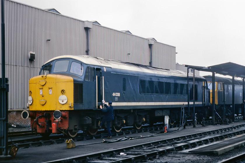 44008 & 47347, fueling point, Toton MPD 
 By the time I had reached the depot again from my visit to the bank, 44008 had disappeared and I was not at all sure where it had gone so I gambled on it being refuelled. I donned my orange tabard again and went in search. Low and behold, I found it at the fuelling point in the company of 47347. 44008 received its smart white roof, stripes and tyres earlier in 1979. It was administered by the staff at Toton and became a firm favourite with enthusiasts and organisers of open days alike. Notice the well turned out driver complete with BR issue cap about to climb into the cab of the Peak. 
 Keywords: 44008 47347 fueling point Toton MPD