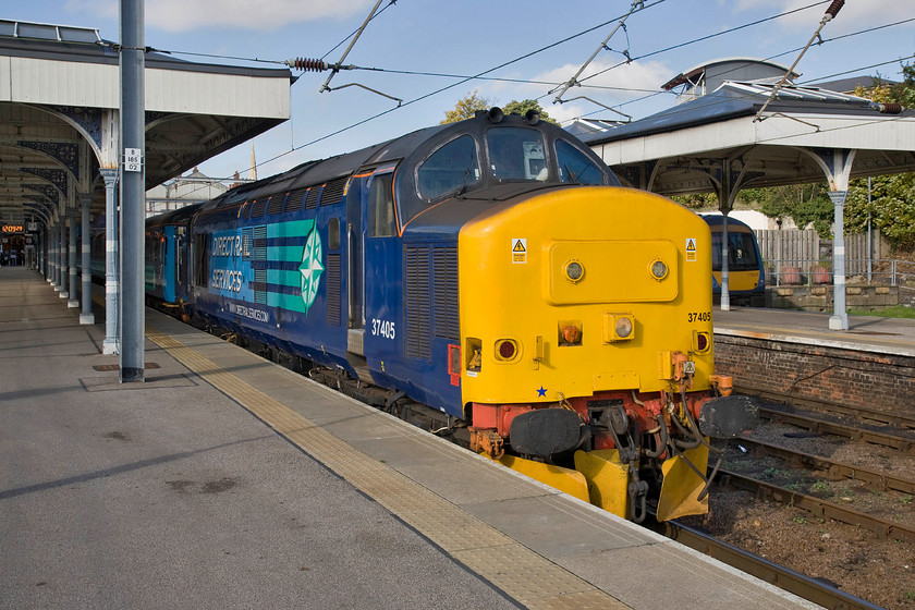 37405, LE 12.36 Norwich-Great Yarmouth (2P20), stabled, Norwich station 
 A proper train sits at Norwich station! DRS' 37405 heads a short rake of Mk. IIF stock that will work out to the coast in a short time. DRS has the contract with Greater Anglia to operate several daily services due to continued shortages of units for a variety of reasons. The operation of these locomotive-hauled services by vintage Class 37s in top and tail mode attracts in a number of enthusiasts that surely must improve off-peak ticket receipts! 
 Keywords: 37405 12.36 Norwich-Great Yarmouth 2P20 stabled, Norwich station DRS GA Great Anglia Direct Rail Services