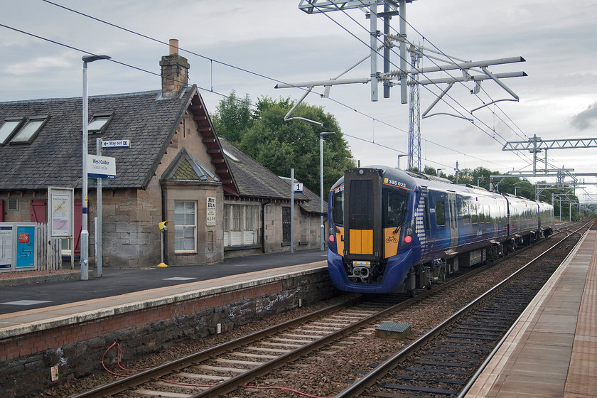 385022, SR 16.25 Edinburgh Waverley-Glasgow Central (2Y49, RT), West Calder station 
 Having seen 385022 earlier in the afternoon a little further west at Cleland station it is seen again working the return 16.25 Edinburgh to Glasgow Central. It is seen passing through West Calder station that is near to Livingston. Like all the other stations on this line, it has been extensively upgraded, but in this case, its original station building remains now the home to the Mei Hua Platform Chinese restaurant. 
 Keywords: 385022 16.25 Edinburgh Waverley-Glasgow Central 2Y49 West Calder station