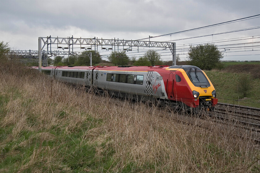 221107, VT 07.17 Chester-London Euston, Gordon's Lodge SP776483 
 Adding a burst of colour to a very grey and dull scene at Gordon's Lodge near Hanslope JnctionVirgin's 221107 races south with the 07.17 Chester to Euston service. It is sobering to think that the Voyagers have been in service on the West Coast route for just over ten years now; where has that time gone? 
 Keywords: 221107 07.17 Chester-London Euston, Gordon's Lodge SP776483 Virgin Trains West Coast Voyager