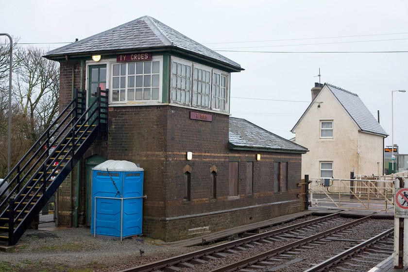 Ty-Croes Signal Box (LNWR, 1892) 
 With its distinctive three high window panes, Ty-Croes signal box is a LNWR structure that is a development of a Saxby & Farmer design. It was opened in 1892 at a remote spot on Anglesey. It is unusual in that it is integrated with the lineman's accommodation in the single storey building. The box was downgraded to the status of a crossing box in 1989 but it remains largely original retaining its timber windows and steps. The triangular slate roof is an interesting feature. 
 Keywords: Ty-Croes Signal Box