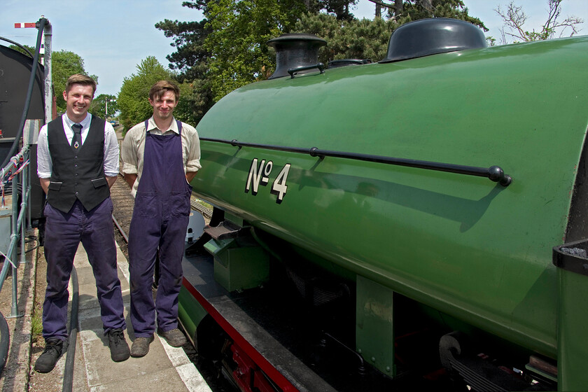 Driver & fireman, No. 4, 12.00 Pitsford return 
 The driver (L) and fireman (R) of the Peckett 0-4-0 No. 4 stand next to their locomotive after arriving with the 12.00 Patsford return working. After riding on the footplate with them and chatting about their voluntary work on the NLR it was reassuring to hear of their dedication and love of their work. It was also encouraging that they are both relatively young with this being encouraging for the future of heritage lines such as the Northampton and Lamport line. 
 Keywords: Driver fireman No. 4 12.00 Pitsford return Peckett 0-4-0ST 2104