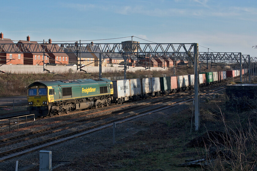 66568, 09.12 Felixstowe North-Trafford Park (4M63, 16E), site of Roade station 
 I was getting concerned that following clearance of this spot a couple of years ago during the COVID-19 shutdown of the WCML that things were regrowing rapidly and that soon photography would become tricky here once again. However, the re-growth has been cut again in the last few weeks keeping it clear for a time to come. 66568 leads the 09.12 Felixstowe to Trafford Park Freightliner past the site of Roade's former station on a bright but chilly winter's afternoon. 
 Keywords: 66568 09.12 Felixstowe North-Trafford Park 4M63 site of Roade station Freightliner