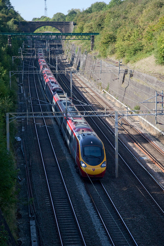 390154, VT 15.30 Birmingham New Street-London Euston (1B62, RT), Roade Cutting 
 390154 'Matthew Flinders' is now out of the light as the bank holiday sun has moved round to the south west putting this side of Roade cutting in the shade. The Pendolino is working the 15.30 Birmingham New Street to London Euston. 
 Keywords: 390154 1B62 Roade Cutting