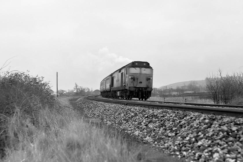 50030, unidentified down working, Heywood Road 
 50030 'Repulse' looks like a steam engine as it takes the Westbury cut-off with an unidentified down working. The white smoke rising above the engine is from the chimney of Westbury cement works. 50030 can still be enjoyed at Peak Rail owned by the Renown Repulse Restoration Group and has undergone an extensive re-build. 
 Keywords: 50030 down working Heywood Road