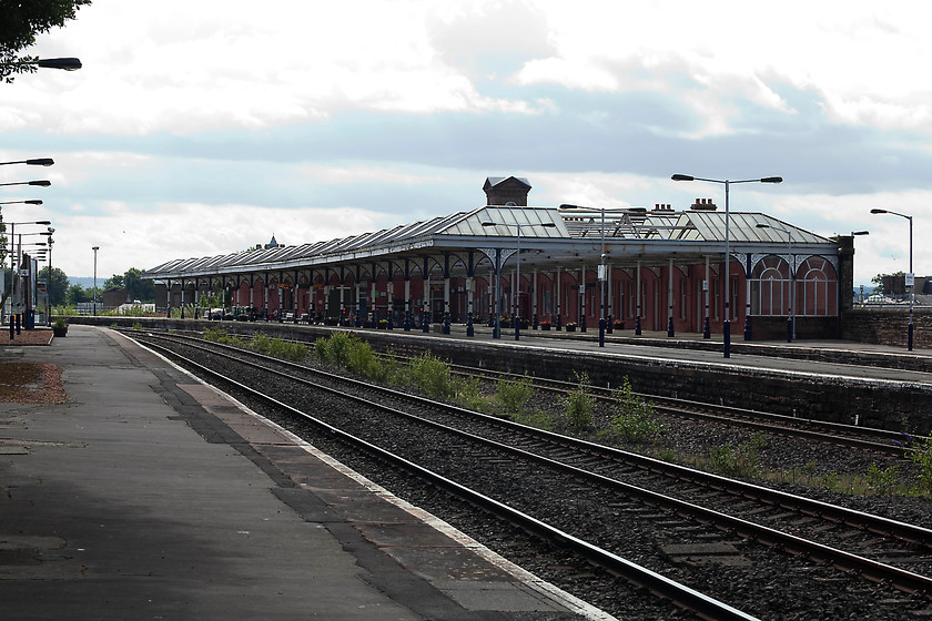 Kilmarnock station 
 Looking south through Kilmarnock station shows an impressive glass canopy covering a number of the remaining platforms. The station was opened by the Kilmarnock and Troon Railway in July 1812 making it one of the earliest to do so in Scotland. 
 Keywords: Kilmarnock station