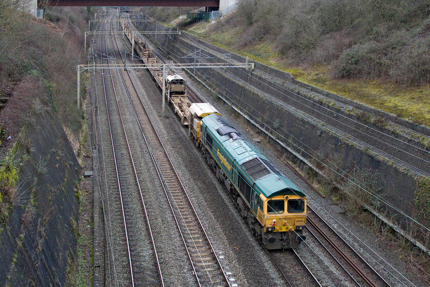 66594, 06.45 Queen's Park-Bescot Yard (6Y61, 56E), Roade cutting 
 Freightliner's 66594 'NYK Spirit of Kyoto' is towed through Roade cutting at the rear of the 06.45 Queen's Park to Bescot Yard engineering train. I had spotted this train on RTT and am glad that I then checked its progress in anticipation of going out to see it as left early being nearly an hour up here at Roade! 
 Keywords: NYK Spirit of Kyoto 66594 06.45 Queen's Park-Bescot Yard 6Y61 Roade cutting