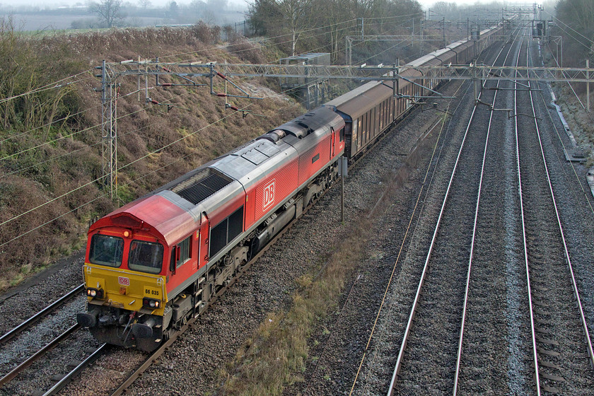 66035, 07.05 Dollands Moor-DIRFT (6M45, 17E), Victoria bridge 
 With the new BREXIT rules and regulations regarding imports from the EU seemingly now sorted out with reference to bottled water the 6M45 07.05 Dollands Moor to Daventry is running again. For a few days after 01.01.21 it, and its balanced empty return working, did not run but normal services appear to have returned as 66035 'Resourceful' leads the train past Victoria bridge between Roade and Ashton. This is my first photograph of this 1998 delivered Class 66 in its DB red livery. 
 Keywords: 66035 07.05 Dollands Moor-DIRFT 6M45 Victoria bridge Daventry DB Resourceful