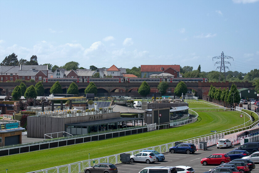 158825 & 158828, AW 13.27 Holyhead-Birmingham International (1I22, RT), Chester racecourse 
 Taken from Chester's Nun's Road that follows the route of the city wall 158825 and 158828 are seen crossing Roodee Viaduct working the 13.27 Holyhead to Birmingham International TfW service. In the foreground, Chester racecourse was busying itself for the next day as there was a seven-race card meet taking place, the Edinburgh Gin Summer Saturday. 
 Keywords: 158825 158828 13.27 Holyhead-Birmingham International 1I22 Chester racecourse TfW Transport for Wales