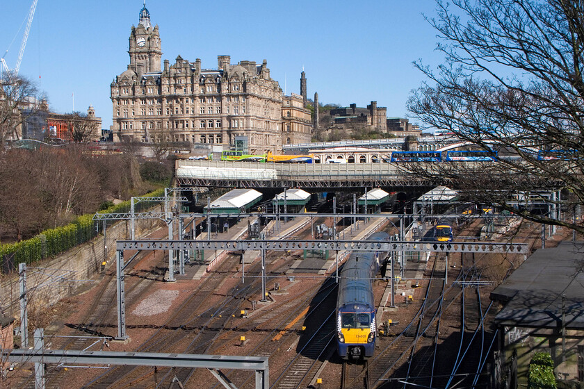 334028, SR 14.37 Edinburgh Waverley-Milngavie, Edinburgh Waverley station from The Mound 
 ScotRail's 334028 negotiates the trackwork in the western throat of Edinburgh Waverley station as it departs with the 14.37 to Milngavie. A glance at the famous clock that rises above the North British Station Hotel (now the Balmoral Hotel) reveals that it is indeed running three minutes early as it has done since the hotel was opened in 1902. This was in an effort to ensure that passengers and hotel residents caught their trains from the station below. The clock runs like this all year except for Hogmanay night when it is set to the correct time! 
 Keywords: 334028 14.37 Edinburgh Waverley-Milngavie Edinburgh Waverley station from The Mound