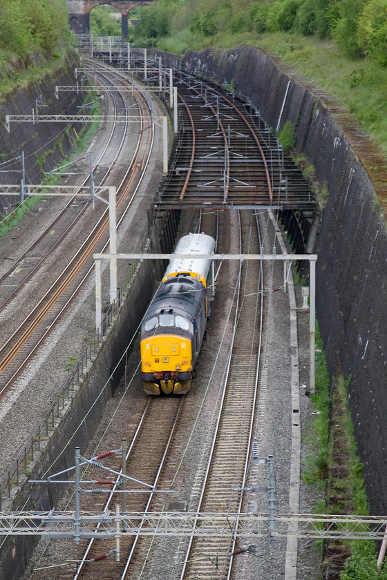 37402 & 975025 Caroline 08.05 Willesden Brent-Derby RTC (5Z02), Roade cutting 
 37402 propels former trailer restaurant buffet car (S60755) now numbered 975025 'Caroline' through Roade cutting as the 08.05 Willesden Brent to Derby RTC working. It will descend and curve away from the WCML fast lines, seen to the left, and pass through the colloquially named birdcage heading towards Northampton. 
 Keywords: 37402 975025 Caroline 08.05 Willesden Brent-Derby RTC 5Z02 Roade cutting