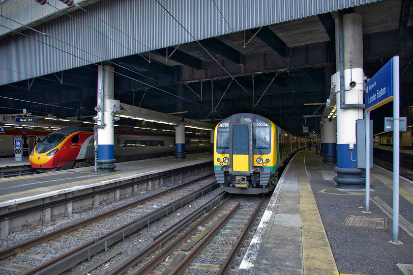 390040, VT 16.00 London Euston-Birmingham New Street (1G34) & 350242, LM 15.34 London Euston-Birmingham New Street (15.34 London Euston-Milton Keynes), London Euston station 
 The concrete brutalist structure of Euston must make it one of the ugliest and most austere stations on the network. Yet, despite its size the platforms, in places such as this are surprisingly narrow not that many trains extend this far out of the darkness and into the most welcome daylight. To the left Virgin's 16.00 'fast' to Birmingham New Street will leave in just over half an hour worked by 390040. Meanwhile, London Midland's 350242 will also work to Birmingham as the 15.34 departure. However, despite the Desiro leaving twenty-five minutes before the Pendolino, it will arrive over an hour later as it stops at many stations and takes the Northampton route. My wife, son and I took the 'slow' train as far as Milton Keynes. 
 Keywords: 390040 16.00 London Euston-Birmingham New Street 1G34 350242 15.34 London Euston-Birmingham New Street London Euston station Virgin Trains West Coast London Midland Desrio Pendolino