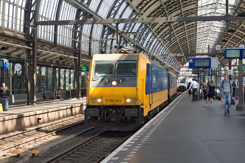 186 043, 15.49 Amsterdam Central-Rotterdam Central (IC 1050), Amsterdam Central station 
 Things are not what they seem here! This is not 186 043 hauling a single coach into Amsterdam Central station! It is in fact going over the crossover from platform 15 to 14 with the rest of the train out of view! Amsterdam has double length platforms that can accommodate two trains on each except for when one of them is a Eurostar, they are too long. This service was the stock for the 15.49 to Rotterdam Central. 
 Keywords: 186 043 15.49 Amsterdam Central-Rotterdam Central (IC 1050) Amsterdam Central station