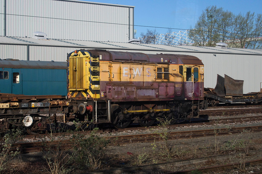 08737, stabled, Crewe South 
 The faded EWS paintwork of shunter 08737 looks pretty poor as it sits idle at Crewe South. It emerged from the works, a short distance from here, as D3905 in 1960 being allocated to Polmadie. It hen moved to Tyseley before returning to Crewe Diesel in 1972 where it has remained ever since. 
 Keywords: 08737 Crewe South