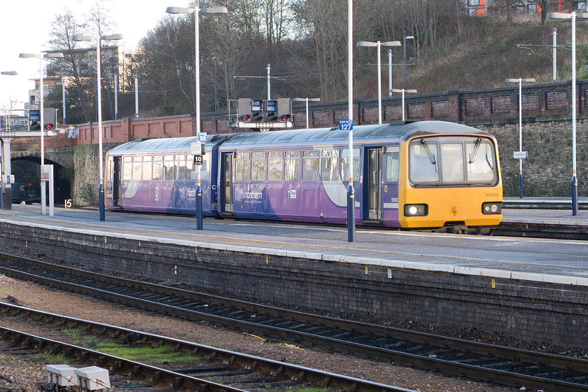 144063 NT 08.15 Adwick-Sheffield (2R56), Sheffield station 
 144063 arrives its destination working the 08.15 2R56 from Adwick. Notice the wires for the Sheffield tram network above the retaining wall behind the train. 
 Keywords: 144063 08.15 Adwick-Sheffield 2R56 Sheffield station