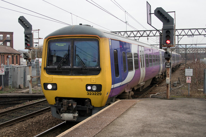 323229, NT 10.40 Hadfield-Manchester Piccadilly (2G50, RT), Guide Bridge station 
 323229 arrives at Guide Bridge with the 10.40 Hadfield to Manchester Piccadilly. The area off to the right was where the once extensive yards used to be situated. Notice the original 1955 latticed stanchions that, when built, carried the 1.5 kV DC wiring. 
 Keywords: 323229 10.40 Hadfield-Manchester Piccadilly 2G50 Guide Bridge station