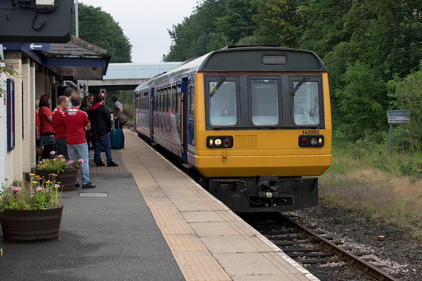 142092, NT 10.44 Saltburn-Bishop Auckland (2D07, 8L), Bishop Auckland station 
 Northern Pacer 142092 arrives at its destination with the 10.44 from Saltburn. For a Sunday morning, the station was surprisingly busy with customers. The station is a single platform affair that at least has some flower tubs and was well maintained. I am not too sure where the two Sheffield United fans, standing on the platform, were going as their team had played a pre-season friendly the previous day at Barnsley. The Pacer, having arrived some eight minutes late, made a hasty return towards Darlington. 
 Keywords: 142092 10.44 Saltburn-Bishop Auckland 2D07 Bishop Auckland station