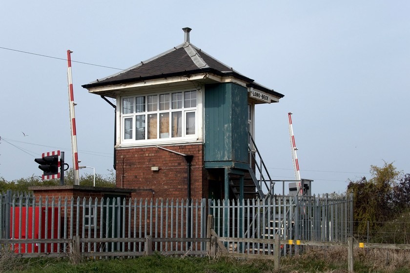 Long Beck signal box (LNER, 1932) 
 The absolutely delightful 1932 LNER signal box at Long Beck. It is located at a level crossing next to the station of the same name that opened in 1985. The lovely square symmetrical design has been somewhat compromised by the ghastly palisade fencing that surrounds it; a sign of the times perhaps? The box used to have an eight lever frame but this has been replaced by a huge array of instruments that control all the lines and workings to the east including the Skinningrove and Boulby mine freight-only lines. 
 Keywords: Long Beck signal box