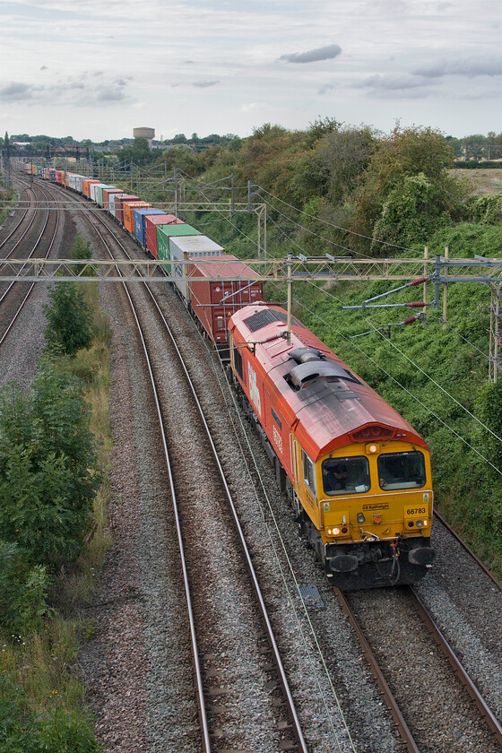 66783, 13.55 Birch Coppice-London Gateway (4L68, RT), Victoria bridge 
 Biffa branded 66783 'The Flying Dustman' picks up speed after the steady climb up from Northampton seen from Victoria bridge just south of Roade. It is leading the 4L68 13.55 Birch Coppice to LondonGateway Intermodal service. 
 Keywords: 66783 13.55 Birch Coppice-London Gateway 4L68 Victoria bridge The Flying Dustman