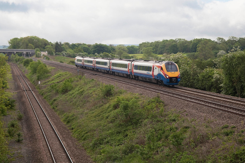 222018 EM 09.29 London St. Pancras-Nottingham (1D29, 2L), Souldrop, Back Lane Bridge 
 222018 is well into its climb of Sharnbrook Bank working the 09.29 St. Pancras to Nottingham. The picture is taken from Back Lane Bridge down a remote byway just outside the village of Souldrop in Bedfordshire. As can be seen clearly, the slow and fast lines are separating here and running at different levels. The bi-directional slow line passes through Sharnbrook Tunnel some further mile behind me whilst the fast lines continue to climb to the summit about two miles northwards. 
 Keywords: 222018 1D29 Souldrop Back Lane Bridge