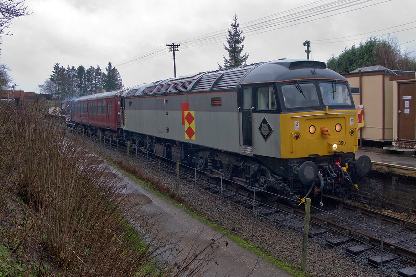 47205, running as 47395, 12.00 Pitsford & Brampton return, Pitsford & Brampton station 
 Bearing its authentic Railfreight Distribution (RfD) livery that it only wore for just over a year back in 1994-95 47205 now renumbered 47395 stands at Pitsford and Brampton station. This is the Northampton and Lamport Railway's only operation diesel at the moment with 31289 receiving some much-needed attention. As this Class 47 has no ETH equipment fitted the guard's van at the rear, that also acts as a DVT, has a generator hence the wisp of exhaust rising from it. 
 Keywords: 47205 47395 12.00 Pitsford & Brampton Pitsford & Brampton station