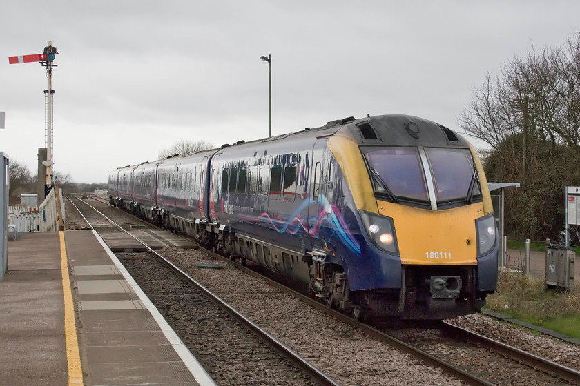 180111, HT 08.58 Hull-London Kings Cross (1A92, RT), Whittlesea station 
 Another ECML diversion passes through Whittlesea station. Hull Trains' 180111 works the 1A82 08.58 Hull to King's Cross through the Cambridgeshire station. I wonder how many of the passengers took any notice of where they were actually going or even recognising that they were 'off-route'? Notice again, the strange angle that the signal arm is sitting at on the top of the post. 
 Keywords: 180111 08.58 Hull-London Kings Cross 1A92 Whittlesea station