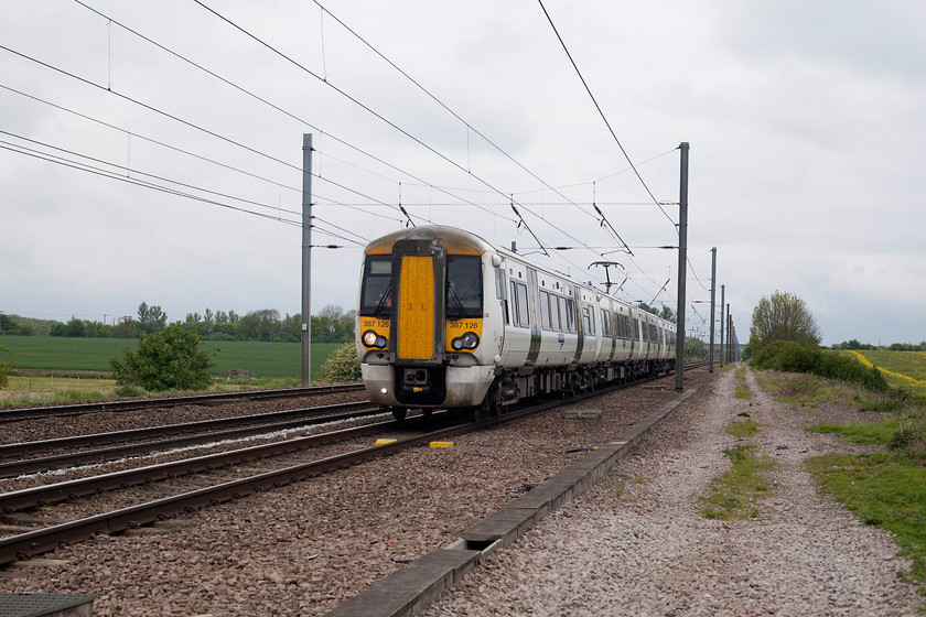 387126, GN 12.18 Peterborough-London Kings Cross (2P49, 5L), White House Crossing TL227777 
 387126 approaches White House Crossing north of Huntingdon working the 12.18 Peterborough to King's Cross. The ECML is three track at this point with and up and down fast line and a down slow on the far left in this image. There are plans to quadruple the line again by reinstating the up slow that would run immediately in front of the camera putting me in the middle of the four foot! 
 Keywords: 387126 2P49 White House Crossing TL227777