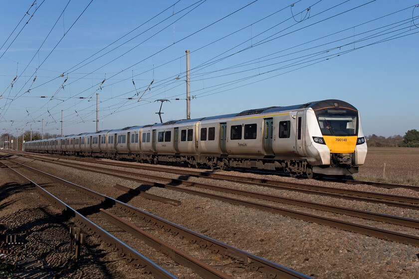 700140, TL 13.24 Peterborough-Horsham (9J36, 13L), Holme Green crossing TL192426 
 On a glorious winter's day such as this linesiding is an absolute pleasure! Despite the chilly air I really prefer photographing trains at this time of year with such a clean quality of light and with the sun at a low angle the lack of deep shadows. Thameslink's 13.24 Peterborough to Horsham service is seen picking up speed after its stop at Biggleswade as it passes Holme Green crossing worked by 700140. 
 Keywords: 700140 13.24 Peterborough-Horsham 9J36 Holme Green crossing TL192426 Thameslink