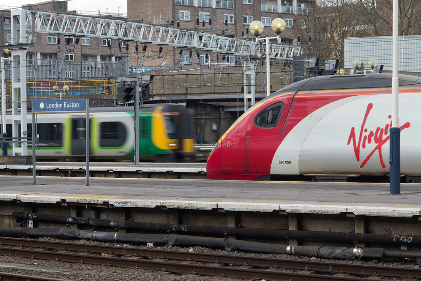 Class 350, LN 15.45 Camden CS-London Euston ECS (5T87) & 390050, VT 16.20 London Euston-Manchester (1H36, 2L), London Euston station 
 390050 'Virgin Invader' waits to leave Euston forming the 16.20 to Manchester Piccadilly. Meanwhile, an unidentified class 350 arrives into an adjacent platform with the 15.45 5T87 ECS from Camden Carriage Sidings. 
 Keywords: ECS 5T87 390050 1H36 London Euston station