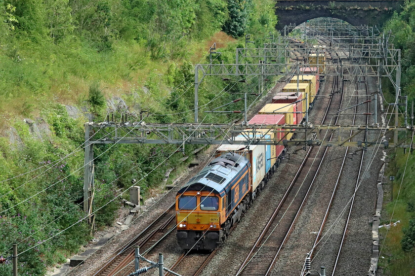 66764, 12.18 London Gateway-Hams Hall (4M47, 1E), Roade cutting 
 Namer 4 - 66764 'Major John Poyntz - Engineer & Railwayman'

Not one of my most commonly photographed Class 66s passes northwards through Roade cutting leading the daily (Mon-Sat) 4M47 12.18 London gateway to Hams Hall. 66764 'Major John Poyntz - Engineer & Railwayman' was named at the Long Marston Rail Live event in June 2021 in memory of the late former inspector who died at the age of eighty-two in 2020. 
 Keywords: 66764, 12.18 London Gateway-Hams Hall (4M47, 1E), Roade cutting GBRf Major John Poyntz Engineer & Railwayman