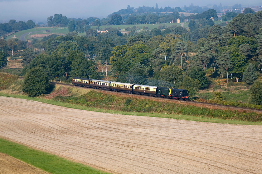 12099 & 13201, 10.10 Bewdley-Kidderminster, Birchen Coppice SO810741 
 Taken from the lofty heights of Birchen Coppice, a housing area to the far south of Kidderminster, the first diesel gala service train of the day is seen on its approach to Foley Park tunnel. The 10.19 Bewdley to Kidderminster shuttle is being hauled by veteran shunters 12099 and 13201. Both these locomotives are Severn Valley residents with the former being the oldest of the two dating from 1952. In the background emerging from the autumnal mists, the West Midlands Safari Park can be seen free from visitor cars as it has yet to open for the day. 
 Keywords: 12099 13201 10.10 Bewdley-Kidderminster Birchen Coppice SO810741 Class 08 Class 11